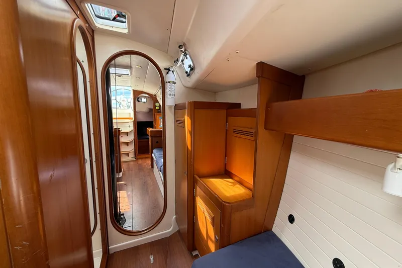 Slide: The Image of Interior of 2013 J Boats J/122 sailboat with wooden cabinetry and cozy sleeping area. - 51