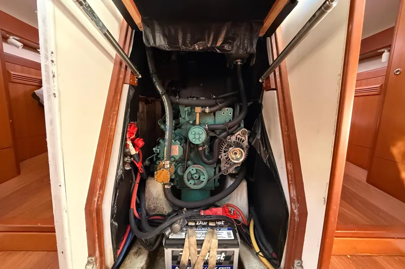 Slide: The Image of Engine compartment of a 2013 J Boats J/122 sailboat, featuring visible components and battery. - 53