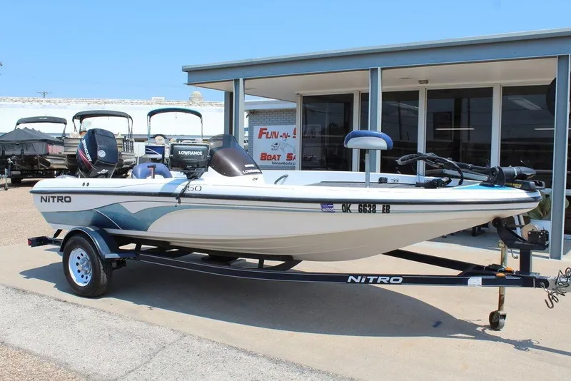 Slide: The Image of 2006 Nitro NX 750 boat on trailer, parked outside a dealership. - 1