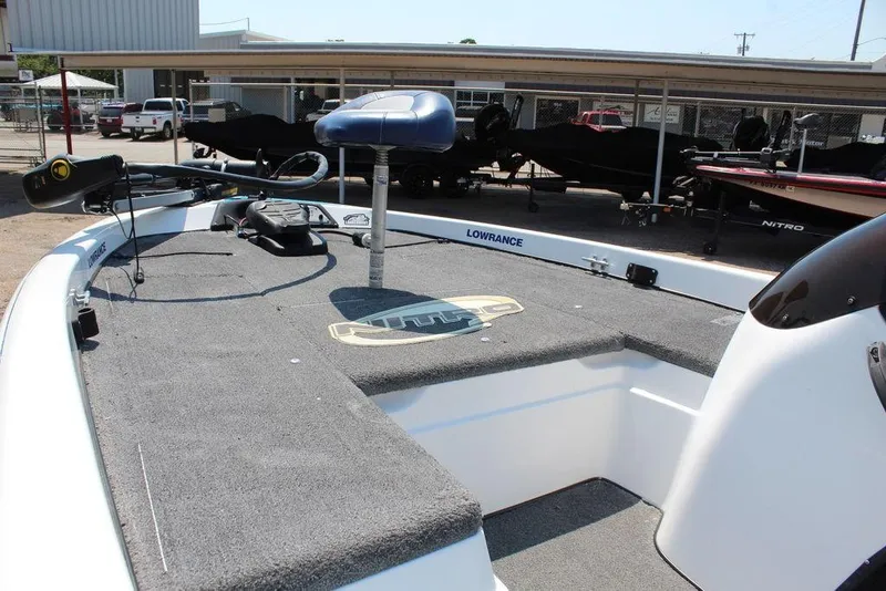 Slide: The Image of 2006 Nitro NX 750 boat deck with Lowrance equipment, parked outdoors. - 12