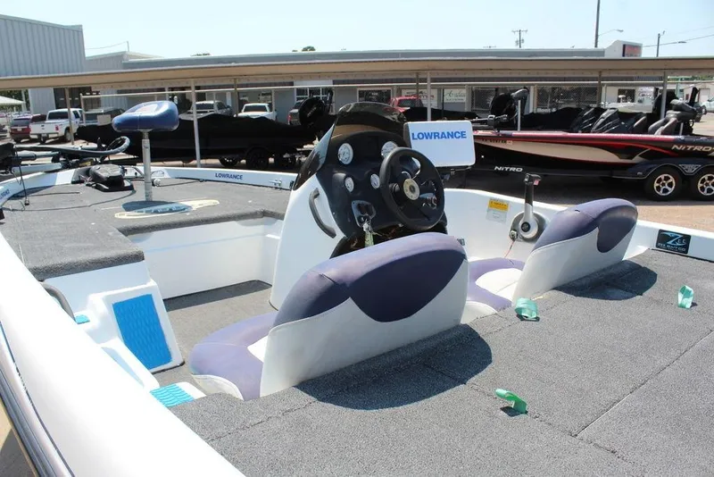 Slide: The Image of 2006 Nitro NX 750 boat interior with steering wheel and Lowrance equipment. - 13