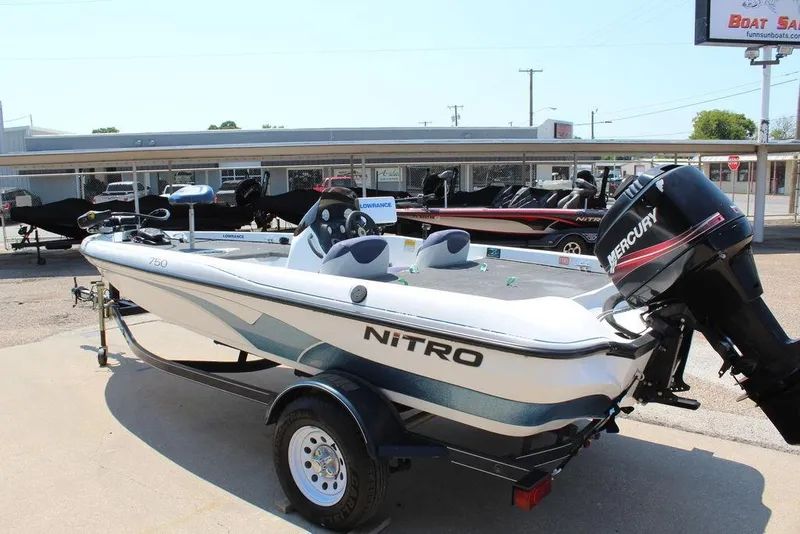 Slide: The Image of 2006 Nitro NX 750 boat with Mercury engine, displayed at a dealership. - 8