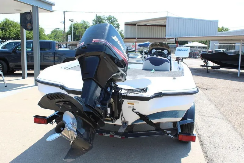 Slide: The Image of 2006 Nitro NX 750 boat with Mercury outboard motor, parked on a trailer. - 9