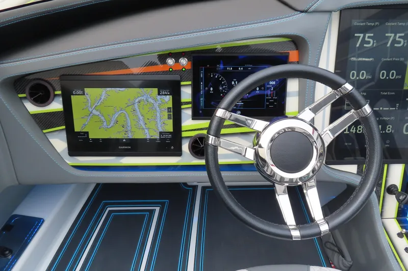 Slide: The Image of Dashboard of 2022 MTI 48 boat with navigation screens and steering wheel. - 12