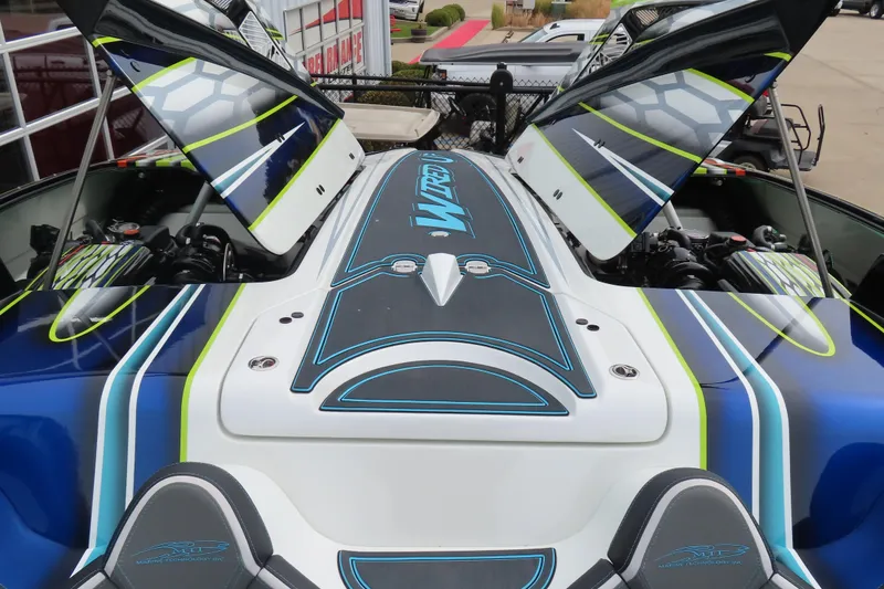 Slide: The Image of 2022 MTI 48 boat with open engine hatches, showcasing sleek design and vibrant colors. - 16