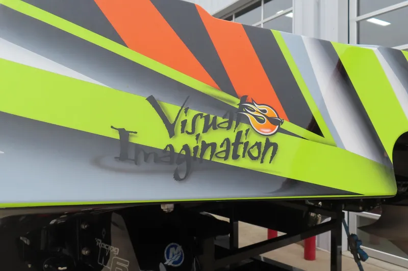 Slide: The Image of 2022 MTI 48 boat with vibrant "Visual Imagination" graphics and bold stripes. - 2