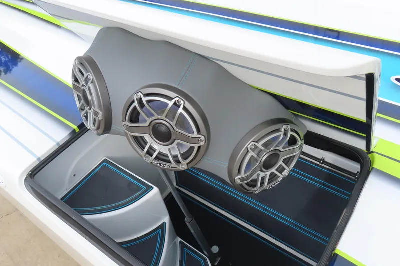 Slide: The Image of 2022 MTI 48 boat with custom audio system and sleek blue-green accents. - 22