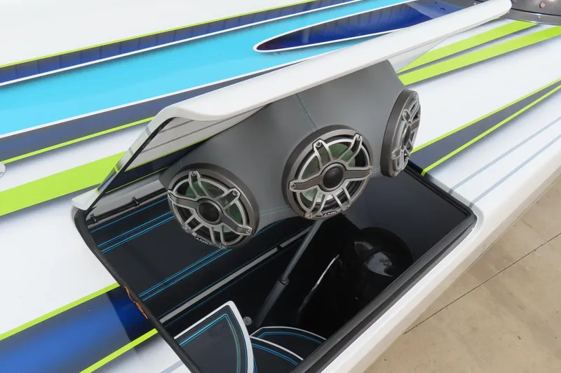 Slide: The Image of 2022 MTI 48 boat with custom audio system and vibrant blue-green design. - 23
