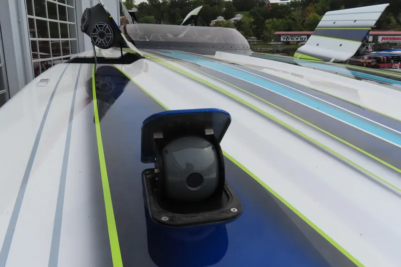 Slide: The Image of 2022 MTI 48 boat with sleek design, featuring vibrant blue and green accents. - 26