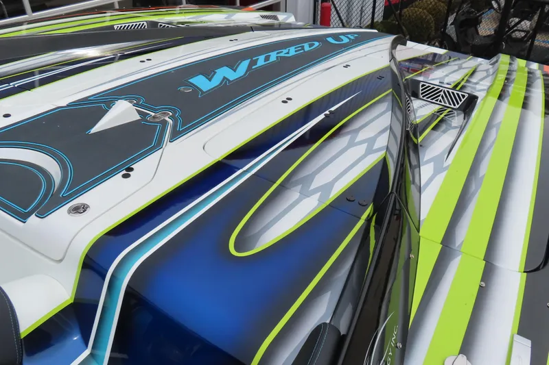 Slide: The Image of Colorful MTI 48 speedboat with vibrant graphics, 2022 model, featuring "Wired Up" design. - 6