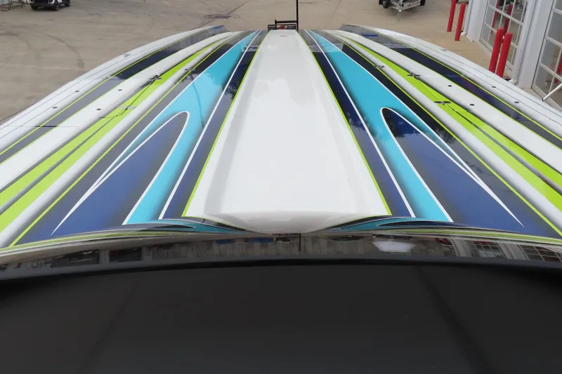 Slide: The Image of Colorful design on 2022 MTI 48 boat, featuring blue, green, and white stripes. - 8