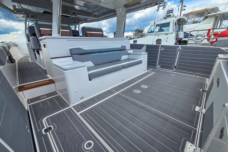 Slide: The Image of 2025 Regal 50 SAV boat interior with sleek seating and modern design. - 14