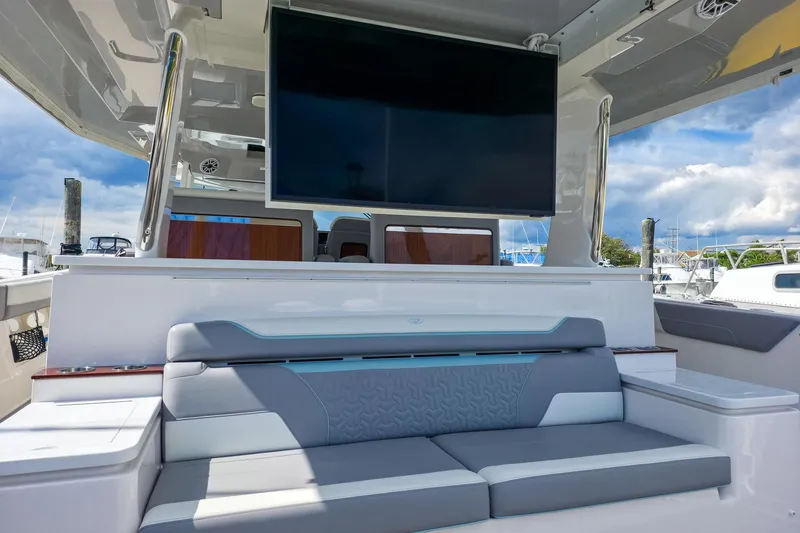 Slide: The Image of Luxurious seating area on 2025 Regal 50 SAV yacht with large TV screen. - 17