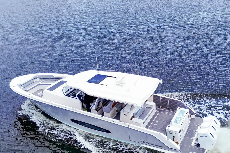 Slide: The Image of 2025 Regal 50 SAV luxury yacht cruising on open water. - 2