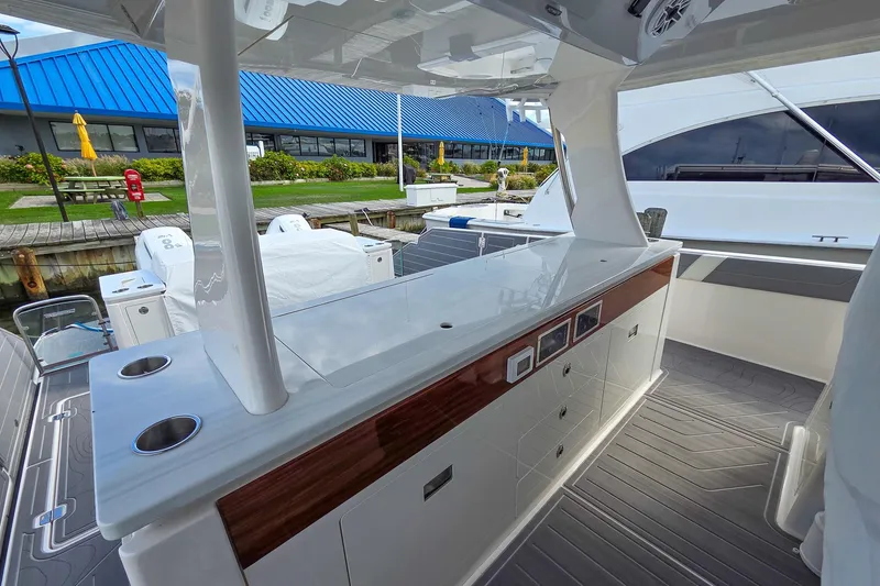 Slide: The Image of 2025 Regal 50 SAV yacht interior with sleek countertops and modern design at a marina. - 20