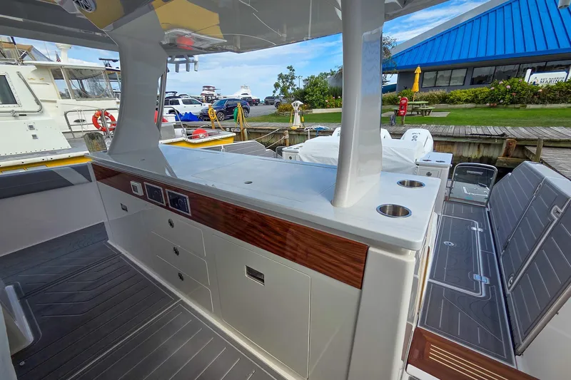 Slide: The Image of 2025 Regal 50 SAV boat interior with sleek design and modern amenities at a marina. - 21