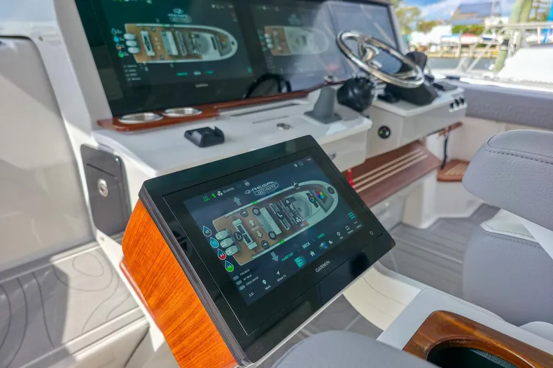 Slide: The Image of 2025 Regal 50 SAV yacht cockpit with advanced touchscreen navigation displays. - 29