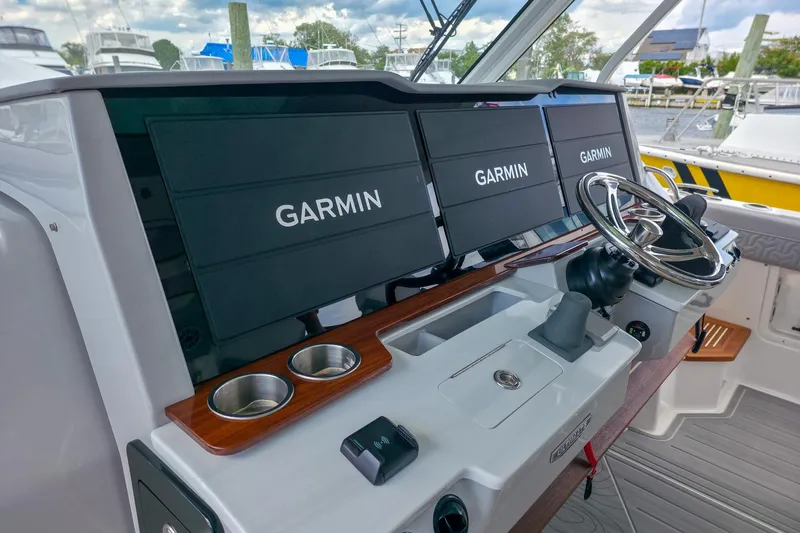 Slide: The Image of 2025 Regal 50 SAV helm with Garmin displays and modern steering wheel. - 30