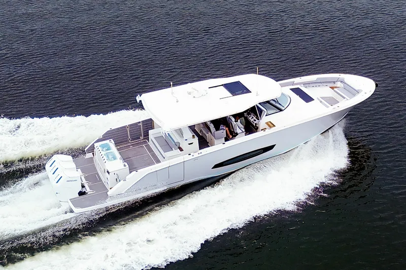 Slide: The Image of 2025 Regal 50 SAV yacht cruising on open water, showcasing sleek design and powerful engines. - 4