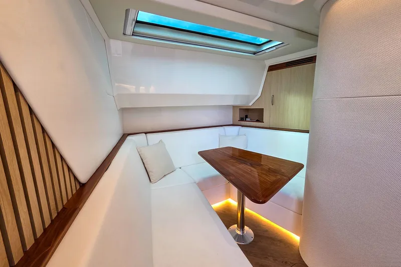 Slide: The Image of Luxurious interior of 2025 Regal 50 SAV yacht with elegant seating and wooden table. - 46