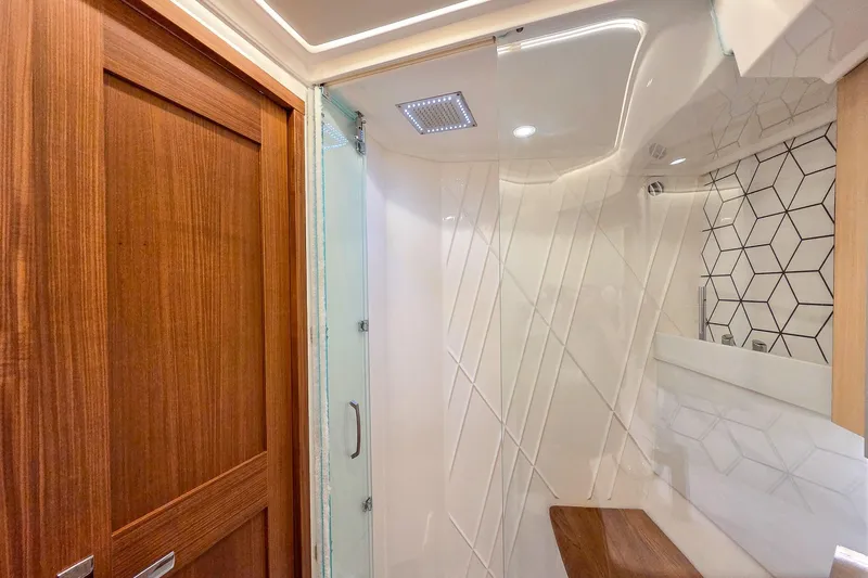Slide: The Image of Luxurious bathroom interior of 2025 Regal 50 SAV yacht with modern design and wood accents. - 49