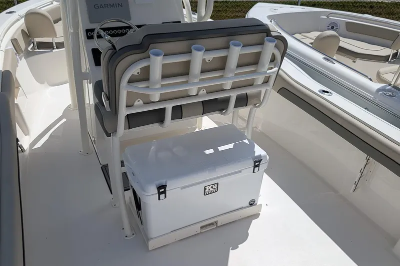 Slide: The Image of 2026 Key West 239 FS boat interior with seating and cooler storage. - 11
