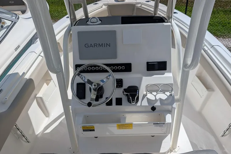 Slide: The Image of 2026 Key West 239 FS boat console with Garmin navigation and steering wheel. - 15