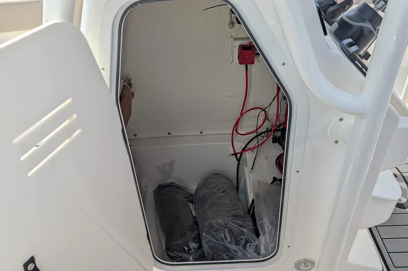 Slide: The Image of Storage compartment of 2026 Key West 239 FS boat, showing wiring and equipment. - 16
