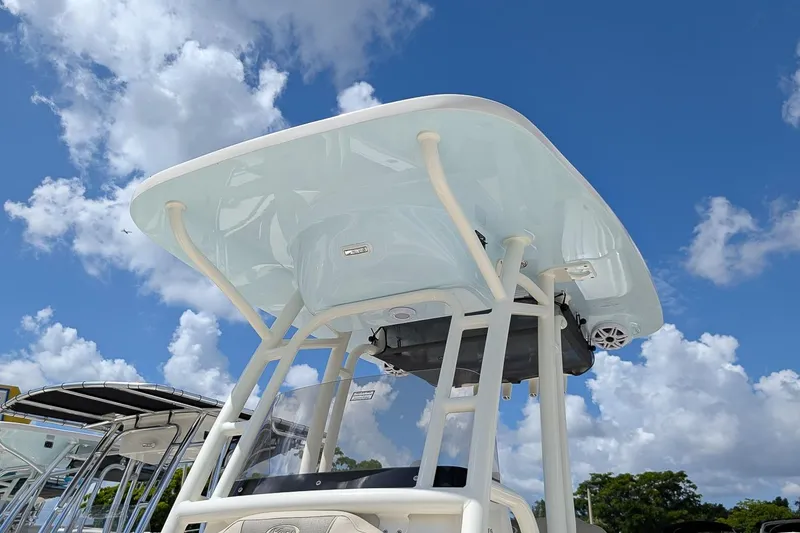 Slide: The Image of 2026 Key West 239 FS boat with T-top against a cloudy blue sky. - 22