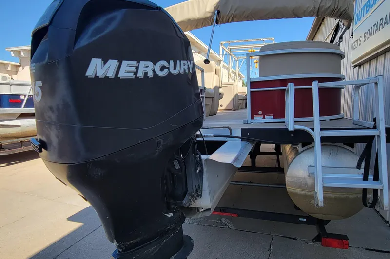 Slide: The Image of 2019 Sun Tracker Party Barge 24 DLX logo on maroon background. - 11