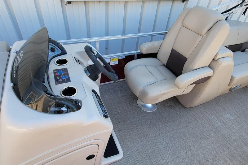 Slide: The Image of 2019 Sun Tracker Party Barge 24 DLX interior seating, beige and brown upholstery. - 16