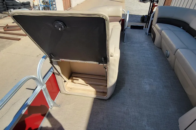 Slide: The Image of Open storage compartment on 2019 Sun Tracker Party Barge 24 DLX boat seat. - 25