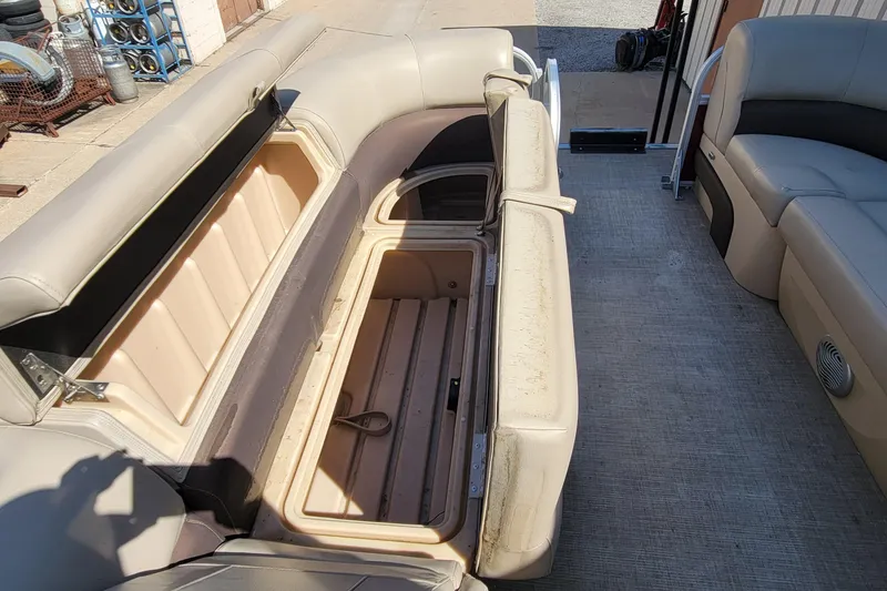 Slide: The Image of 2019 Sun Tracker Party Barge 24 DLX interior with open storage compartment. - 28