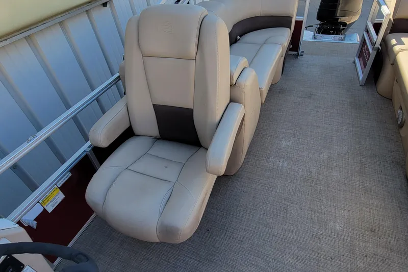 Slide: The Image of 2019 Sun Tracker Party Barge 24 DLX interior with beige seating and spacious layout. - 32
