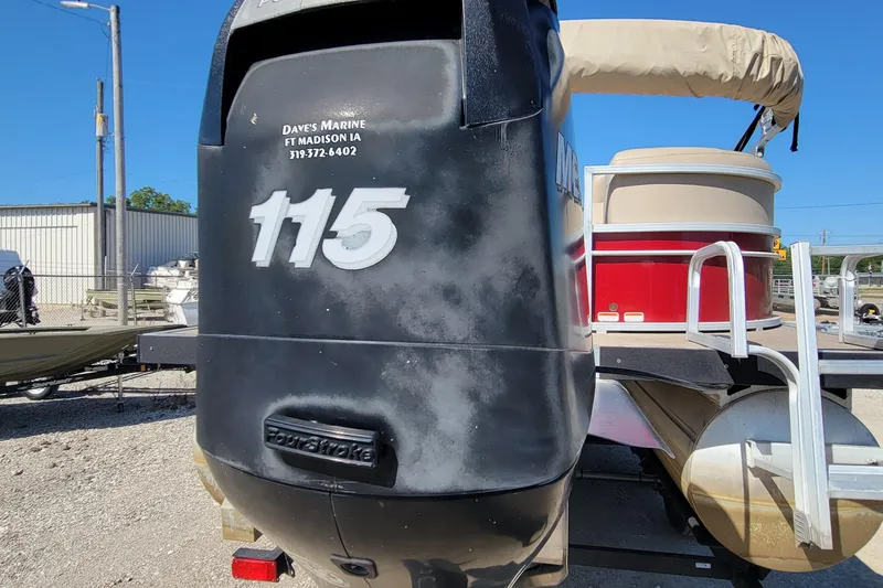 Slide: The Image of 2019 Sun Tracker Party Barge 24 DLX pontoon boat on trailer, outdoor setting. - 5