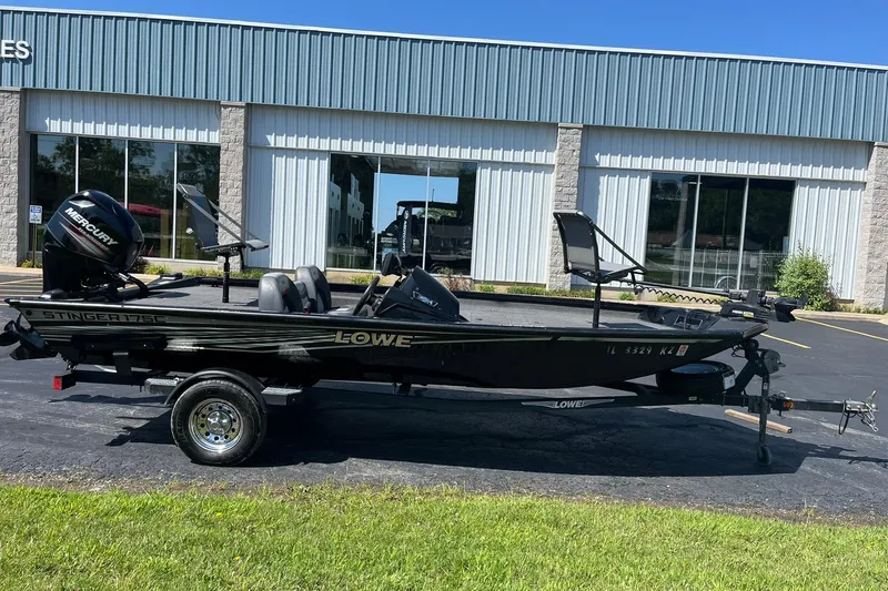 Slide: The Image of 2019 Lowe Stinger 175C boat on trailer outside a building. - 1