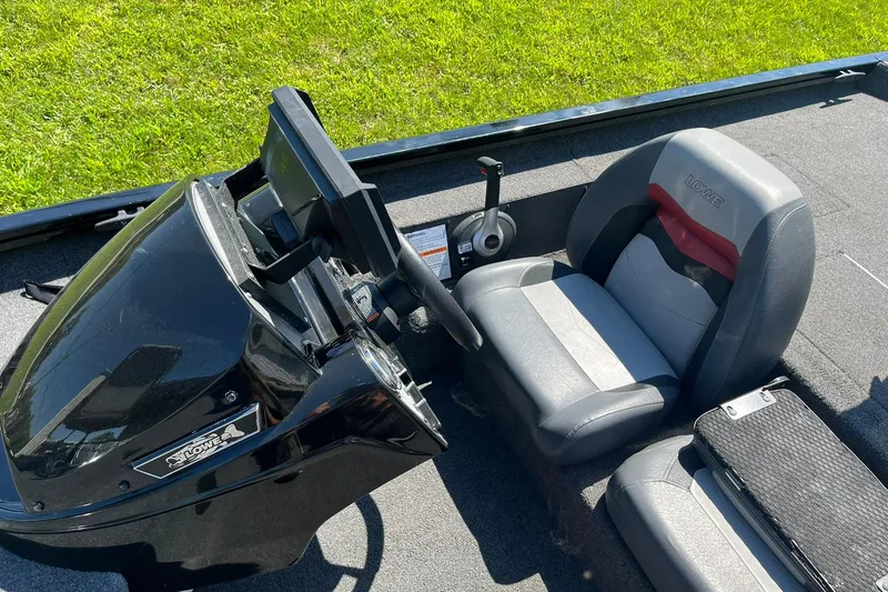 Slide: The Image of 2019 Lowe Stinger 175C boat interior with steering console and seat. - 10
