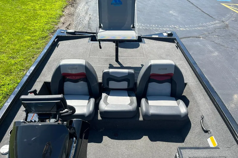Slide: The Image of 2019 Lowe Stinger 175C boat interior with three seats and steering console. - 12