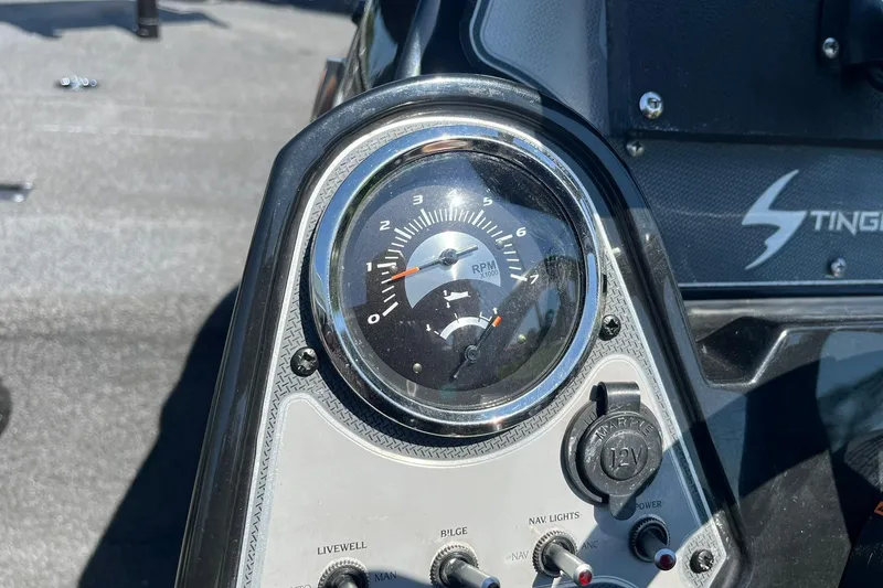 Slide: The Image of Close-up of 2019 Lowe Stinger 175C boat dashboard with RPM gauge and controls. - 14