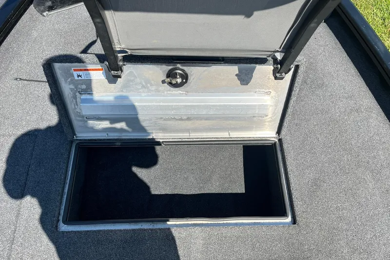 Slide: The Image of Open storage compartment on 2019 Lowe Stinger 175C boat, showing interior space. - 17