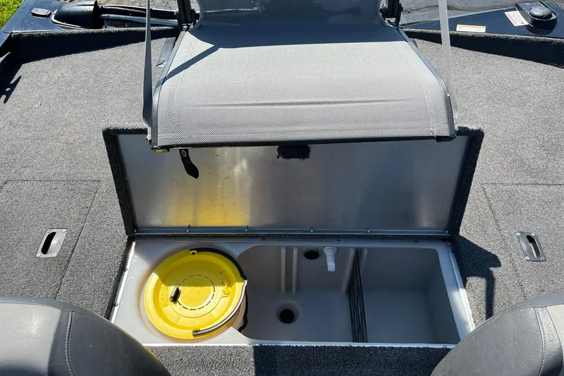 Slide: The Image of 2019 Lowe Stinger 175C boat interior with open storage compartment and yellow lid. - 21