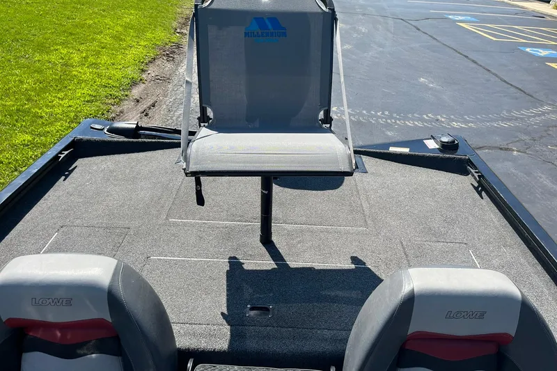 Slide: The Image of 2019 Lowe Stinger 175C boat interior with seating and carpeted deck. - 23