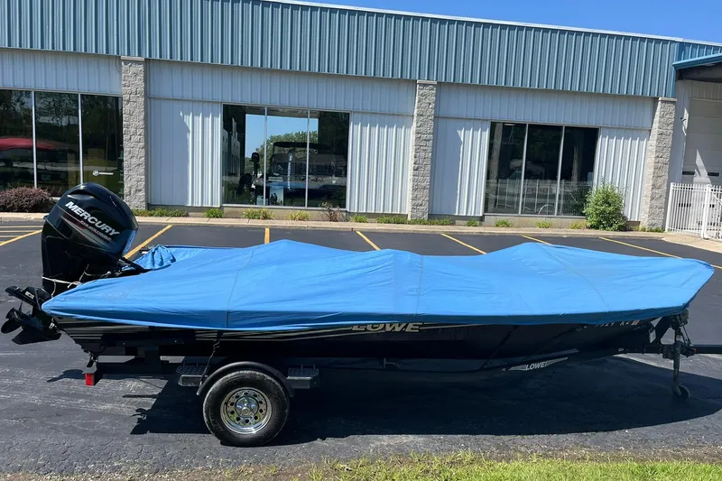 Slide: The Image of 2019 Lowe Stinger 175C boat with blue cover and Mercury outboard motor. - 30