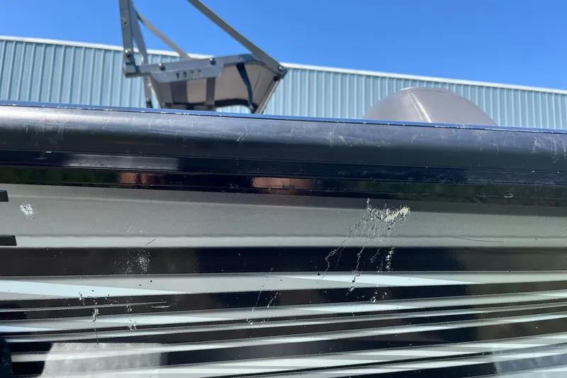 Slide: The Image of 2019 Lowe Stinger 175C boat with visible scratches and marks on the side. - 31