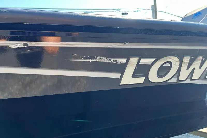 Slide: The Image of 2019 Lowe Stinger 175C boat with visible scratches on the side. - 33