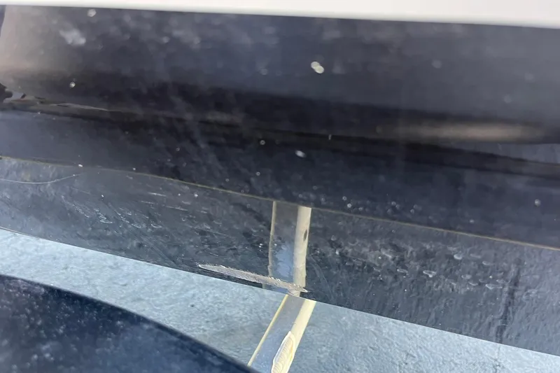 Slide: The Image of Close-up of a 2019 Lowe Stinger 175C boat hull with visible scratches. - 35