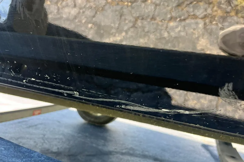 Slide: The Image of Close-up of 2019 Lowe Stinger 175C boat hull with visible scratches. - 36