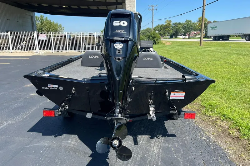 Slide: The Image of 2019 Lowe Stinger 175C boat with 60 HP engine, parked outdoors. - 4