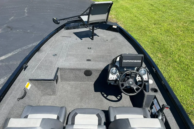 Slide: The Image of 2019 Lowe Stinger 175C boat interior with steering console and seating. - 7