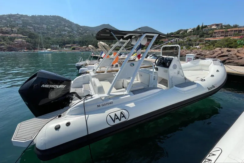 Slide: The Image of 2025 Aqvaboats Luxrib 22 docked in a scenic marina with hills in the background. - 13